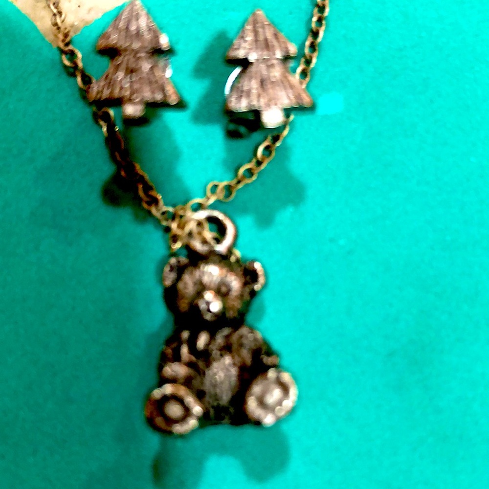 RUSS earrings and necklace inside a miniature trunk.